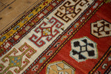 Stylized rams horn and geometric guls on the wide ivory border of an antique Caucasian runner.
