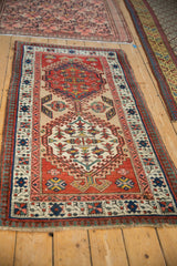 Angled view of a vintage Serab runner's geometric medallion and reciprocating pawn design border.