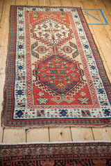 Full view of a vintage Persian Serab runner with double geometric medallions and pawn design borders.