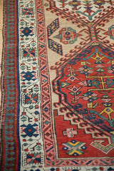 Detail of the vintage Serab runner's pawn and vine motif borders in blush pink, blue, and sand.