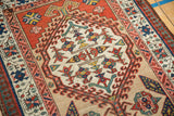 Angled detail of a Persian Serab rug's geometric floral blossoms and hook and latch motifs.
