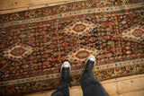 Antique Kurdish Hamadan runner, intricate brown field, floral motifs, ivory medallions, vine border.