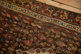 Antique Kurdish Hamadan runner detail: chocolate, madder red, ivory floral patterns, aged textured pile.