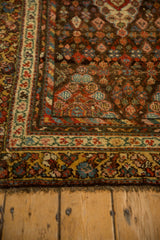 Antique Kurdish Hamadan rug corner: chocolate field, ivory vine border, saffron floral border.