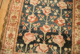 Antique Kurdish Hamadan runner's abrashed dusty navy field, germinating roses, and plant border design.