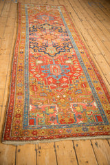 Angled view of an antique Heriz rug runner, highlighting its full length and traditional geometric pattern.