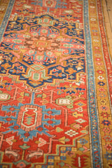 Angled view of an antique Heriz runner's blue abrash, gold ochre border, and low-pile texture.