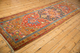 Angled view of an antique Heriz runner, displaying its grand scale and traditional geometric design.