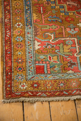 Gold ochre and light blue floral borders on the corner of an antique Persian Heriz rug runner.