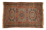 Antique Caucasus Soumac carpet with three large gul medallions in madder red, cobalt blue, and jade green.