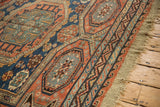 Reciprocating wave border and original macrame fringe on an antique Soumac design carpet.