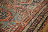 Complex geometric borders of a Soumac carpet featuring zig-zag and wave motifs in red and blue.
