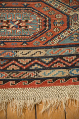 Original macrame fringe and detailed zig-zag borders on an antique hand-woven Soumac design carpet.