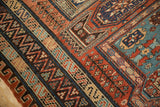 Complex geometric borders including zig-zag and serpent motifs on an antique Soumac carpet.
