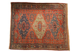 Antique Soumac carpet with triple medallions in jade green and navy blue on a madder red field.