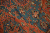 Intricate geometric patterns and color abrashes on an antique hand-woven Soumac carpet.