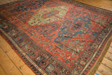 Angled view of a Caucasian Soumac carpet highlighting starburst motifs and rich color abrashes.