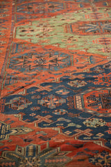 Textured flatweave of a geometric Soumac carpet in red, blue, and green.