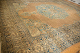 Ram's horn scrolled spandrel and meandering vine border on an antique Persian Kerman carpet.