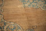Textured close-up of an antique Kerman carpet with low pile, showing visible knot heads and foundation.