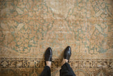Antique Kerman carpet showing the distressed, low pile and detailed perched love birds motif.