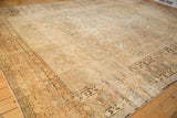 Meandering vine and palmette border of a distressed antique Kerman with a low-pile texture.