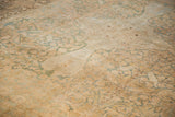 Detail of the distressed Kerman's low pile, revealing a sand and pale seafoam green pattern.