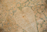 Isolated wear on an antique Kerman rug revealing the woven foundation and knot heads.