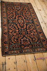 Hand-knotted Sarouk runner's side selvage, palmette border, and navy blue floral motifs.