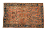 Antique Mohajeran Sarouk rug, dusty blush field, indigo border, with floral arabesques and pomegranate motifs.