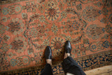 Antique Mohajeran Sarouk rug with dusty blush field, floral arabesques, and indigo border.