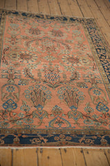 Close-up of antique Mohajeran Sarouk rug's dusty blush field with transitional blue floral arabesques.