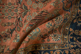 Draped detail of antique Mohajeran Sarouk rug, dusty rose field with floral motifs, indigo border.