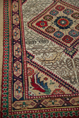 Detailed corner view of a vintage Serab rug showing its cartouche and reciprocating pawn design borders.