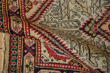 Folded vintage Serab showing the textured pile, knot heads, and geometric pawn border design.
