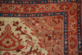 Close-up of antique Malayer rug's ruby red, sapphire blue, and beige traditional floral border.