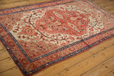 Fine Malayer rug corner, intricate ruby red vines, sapphire blue geometric border, visible wear.