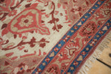 Antique Mishan Malayer rug detail: sapphire blue border, ruby red florals, beige ground, fringe.