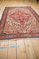 An Antique Fine Malayer rug's rebuilt fringe, ruby red border, and finely detailed patterns.