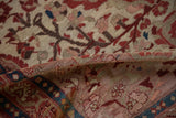 Folded antique Malayer rug, revealing hand-knotted ruby red blossoms, sapphire blue border, and patina.