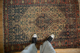 Antique Senneh rug featuring diamond medallion, Herati pattern in navy, ivory, pale brick red, with even wear.
