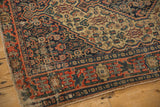 Geometric border and intricate Herati field with visible foundation on antique Senneh rug.