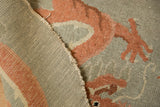 The hand-knotted foundation, secured selvage, and low wool pile of an antique Art Deco rug.