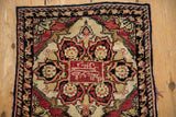 Close-up of the central inscription cartouche and floral arabesques on an antique Persian Yezd mat.