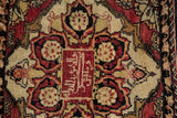 Close-up of the red signature cartouche and inscription panel on an antique Persian Yezd rug.