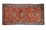 Vintage Persian Lilihan rug with allover palmettes and blossoms on an abrashed cranberry red field.