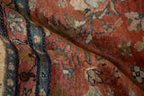 Folded view of a vintage Lilihan rug highlighting the low, even pile and abrashed red ground.