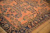 Antique Lilihan rug corner detail, highlighting dusty rose floral sprays and blue Herati border motifs.