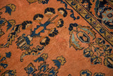 Antique Lilihan rug: dusty rose field, sapphire blue floral sprays, Herati border, subtle patina.