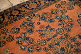 Antique Lilihan rug featuring dusty rose field, sapphire blue floral sprays, and Herati border.